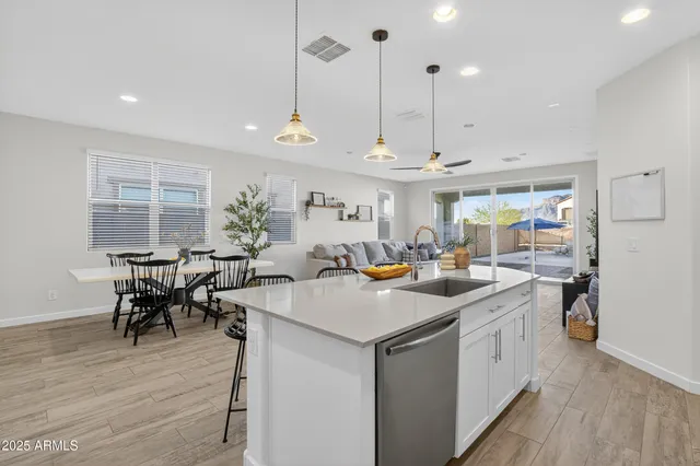 a kitchen with a table a refrigerator and a counter top space