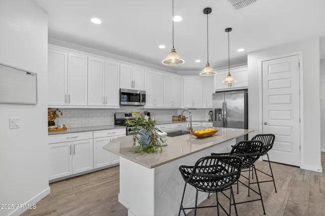 a view of a kitchen and dining area with wooden floor