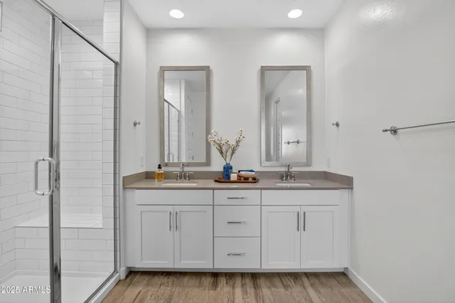 a bathroom with a double vanity sink and mirror
