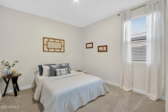 a bedroom with a bed and a table