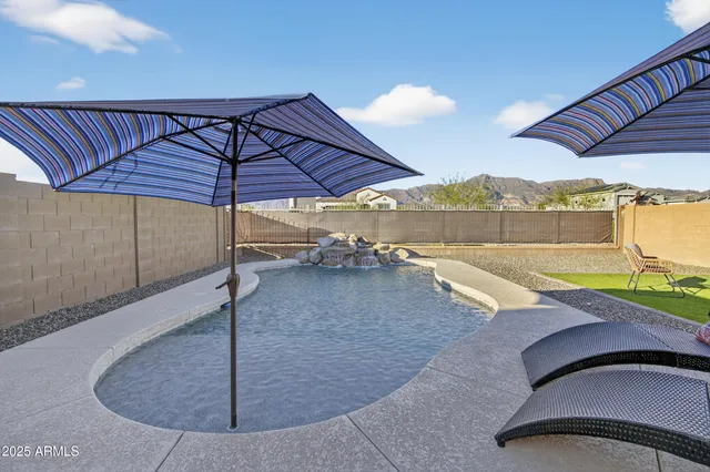 a view of a swimming pool with a lounge chairs