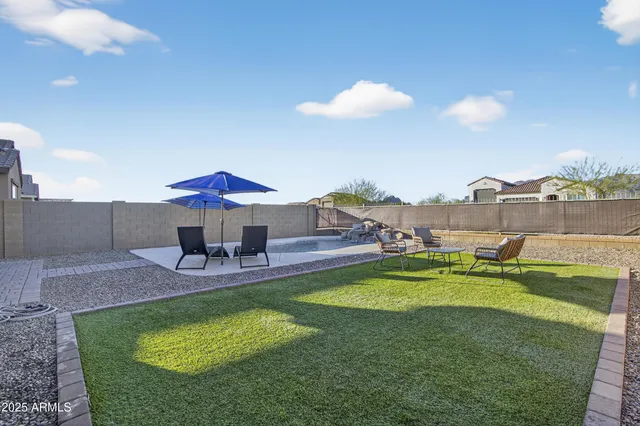 a swimming pool with outdoor seating and yard