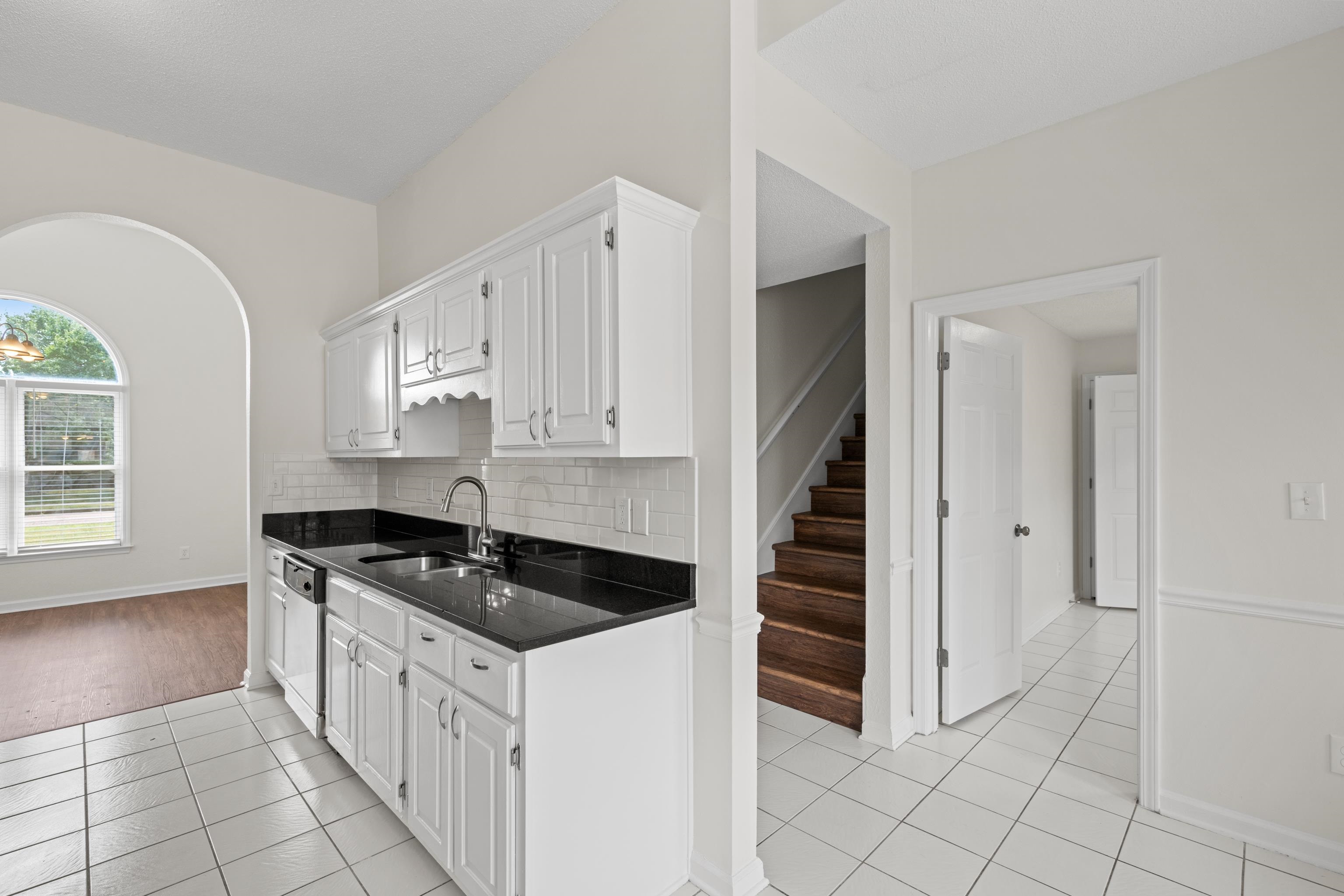 8016 Cale Falls Lane Bartlett, TN 38002 - Photo 11 of 37 a kitchen with granite countertop a stove a sink and a refrigerator