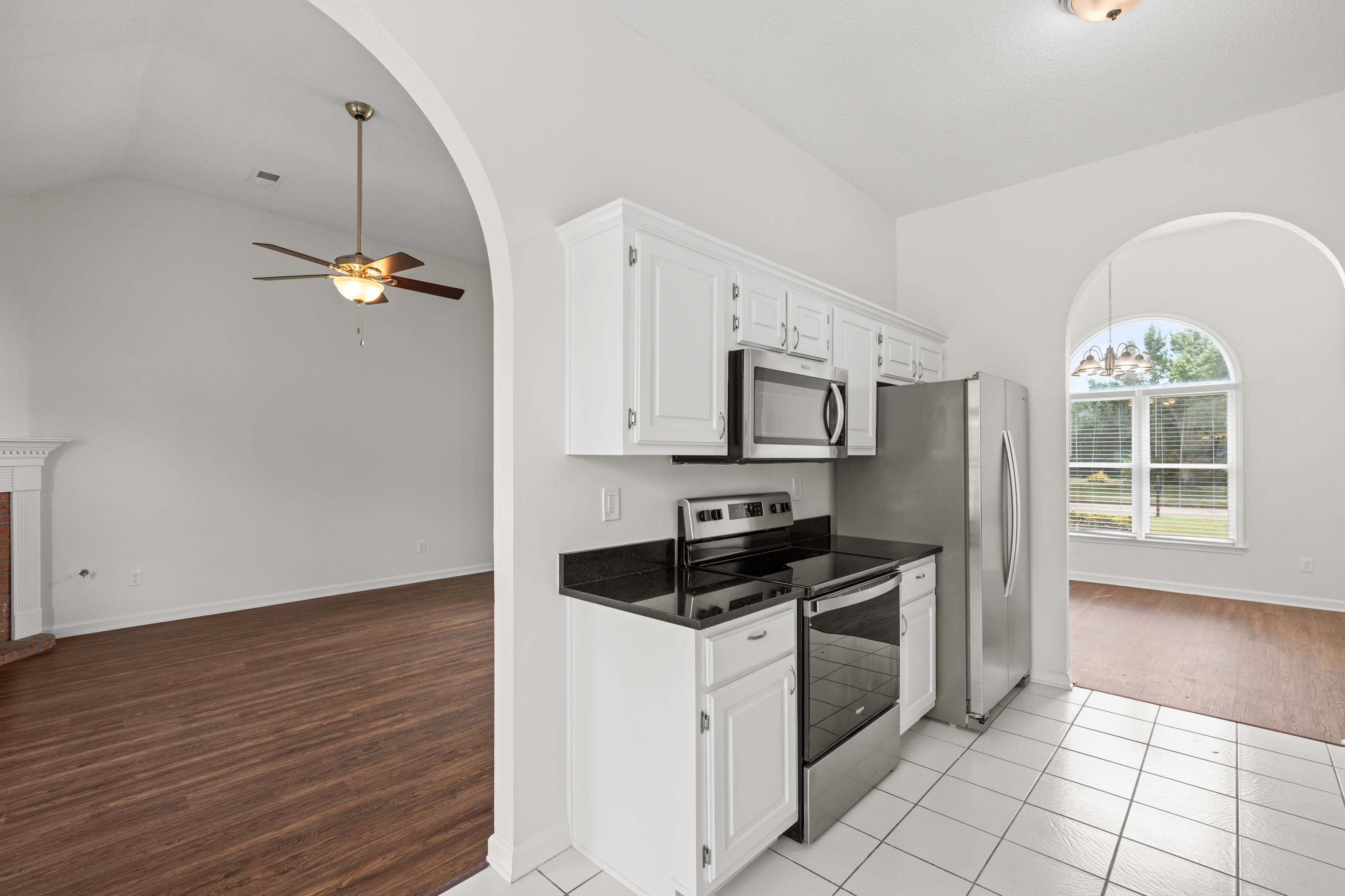 8016 Cale Falls Lane Bartlett, TN 38002 - Photo 12 of 37 a kitchen with granite countertop a stove a sink and a refrigerator