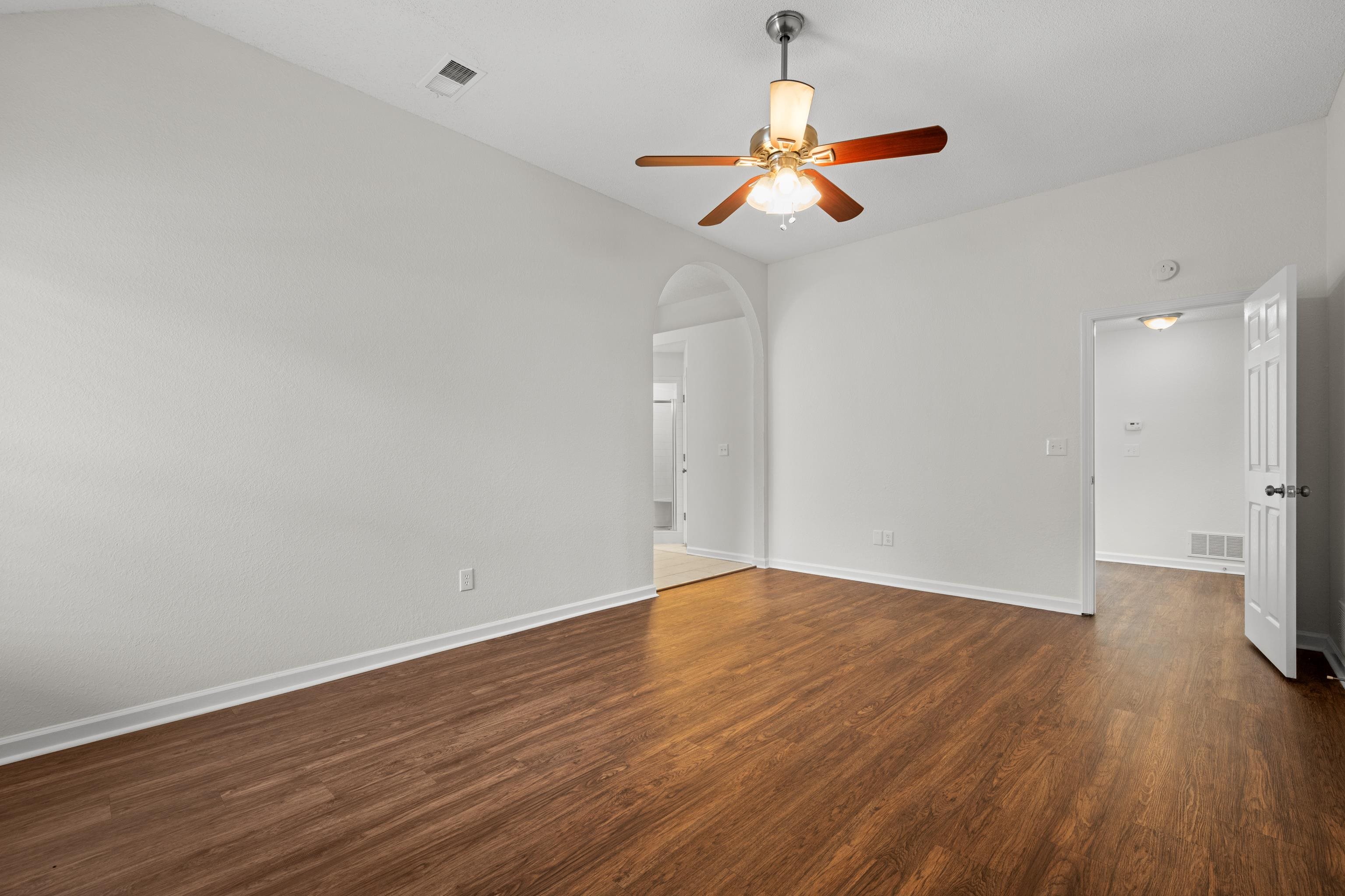 8016 Cale Falls Lane Bartlett, TN 38002 - Photo 17 of 37 a view of an empty room with wooden floor