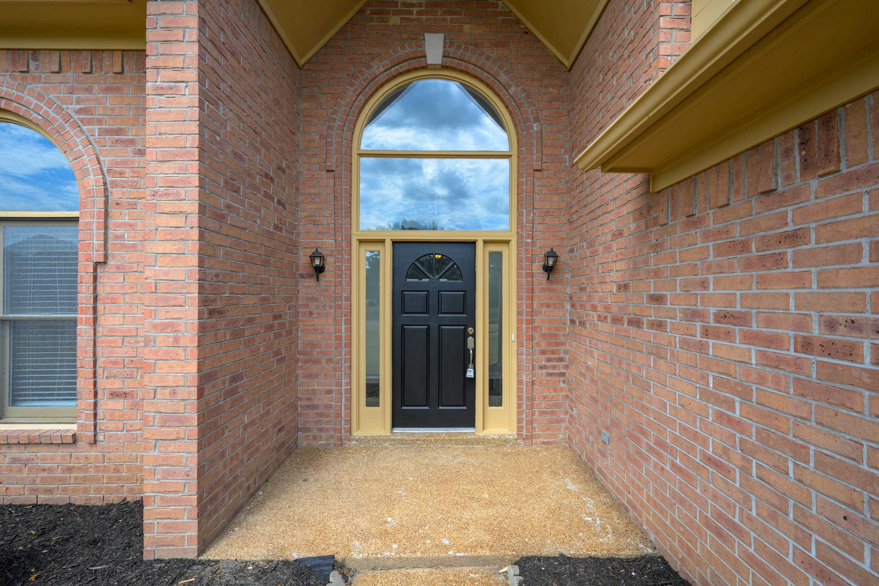 8016 Cale Falls Lane Bartlett, TN 38002 - Photo 2 of 37 a front view of a house with a garden