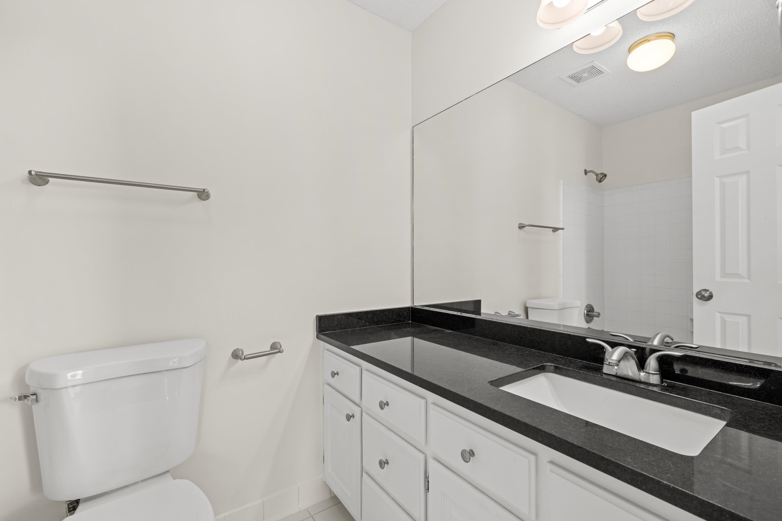 8016 Cale Falls Lane Bartlett, TN 38002 - Photo 24 of 37 a bathroom with a granite countertop sink and a mirror