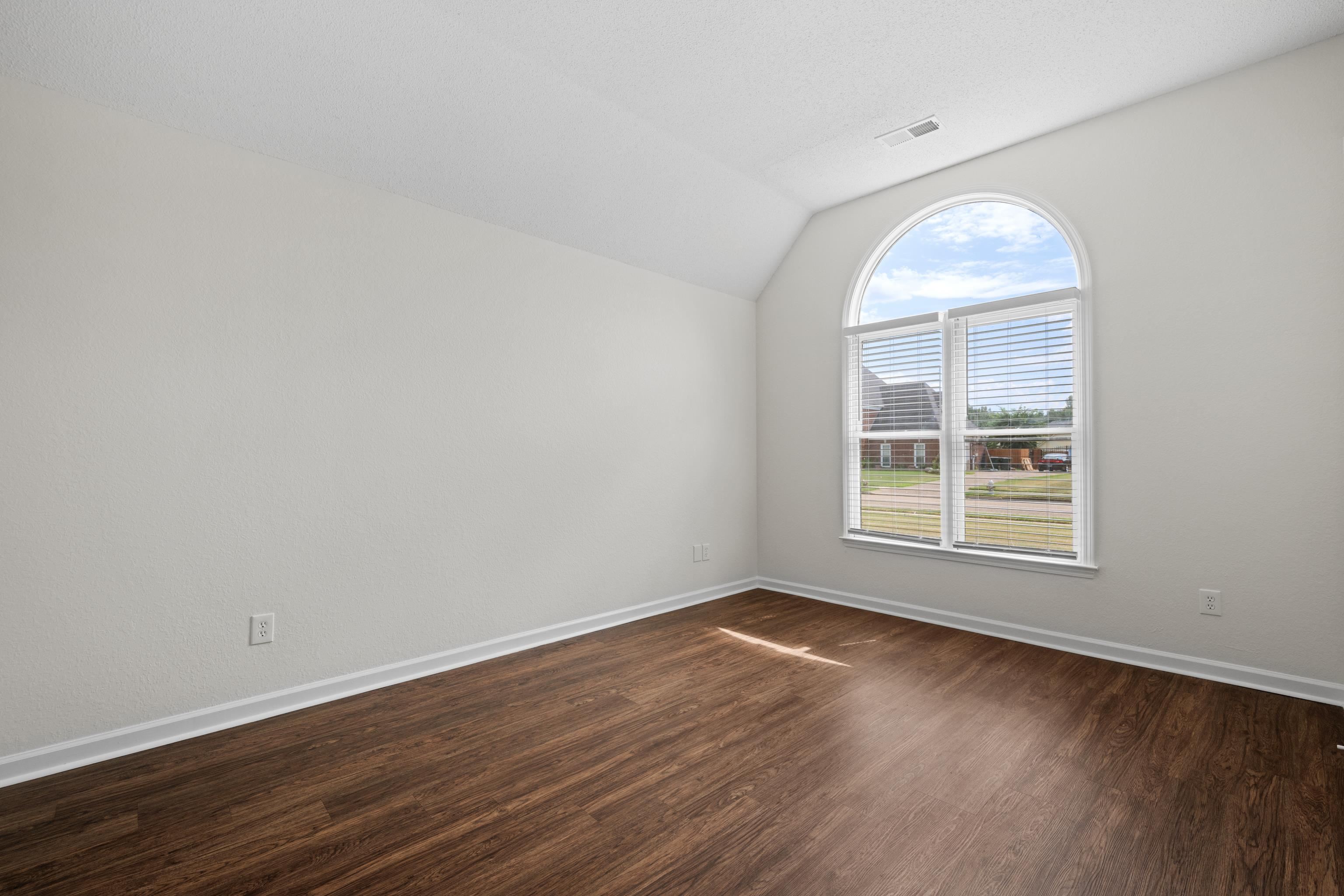 8016 Cale Falls Lane Bartlett, TN 38002 - Photo 25 of 37 an empty room with wooden floor and windows