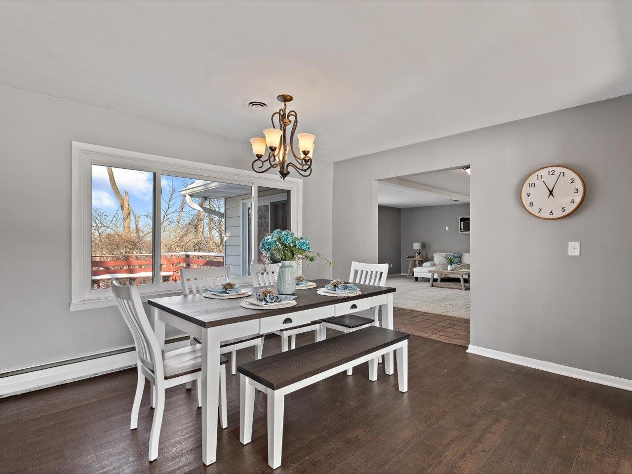 8210 Ridgewood Road Rock Island, IL 61201 - Photo 16 of 60 a view of a dining room with furniture a chandelier and wooden floor