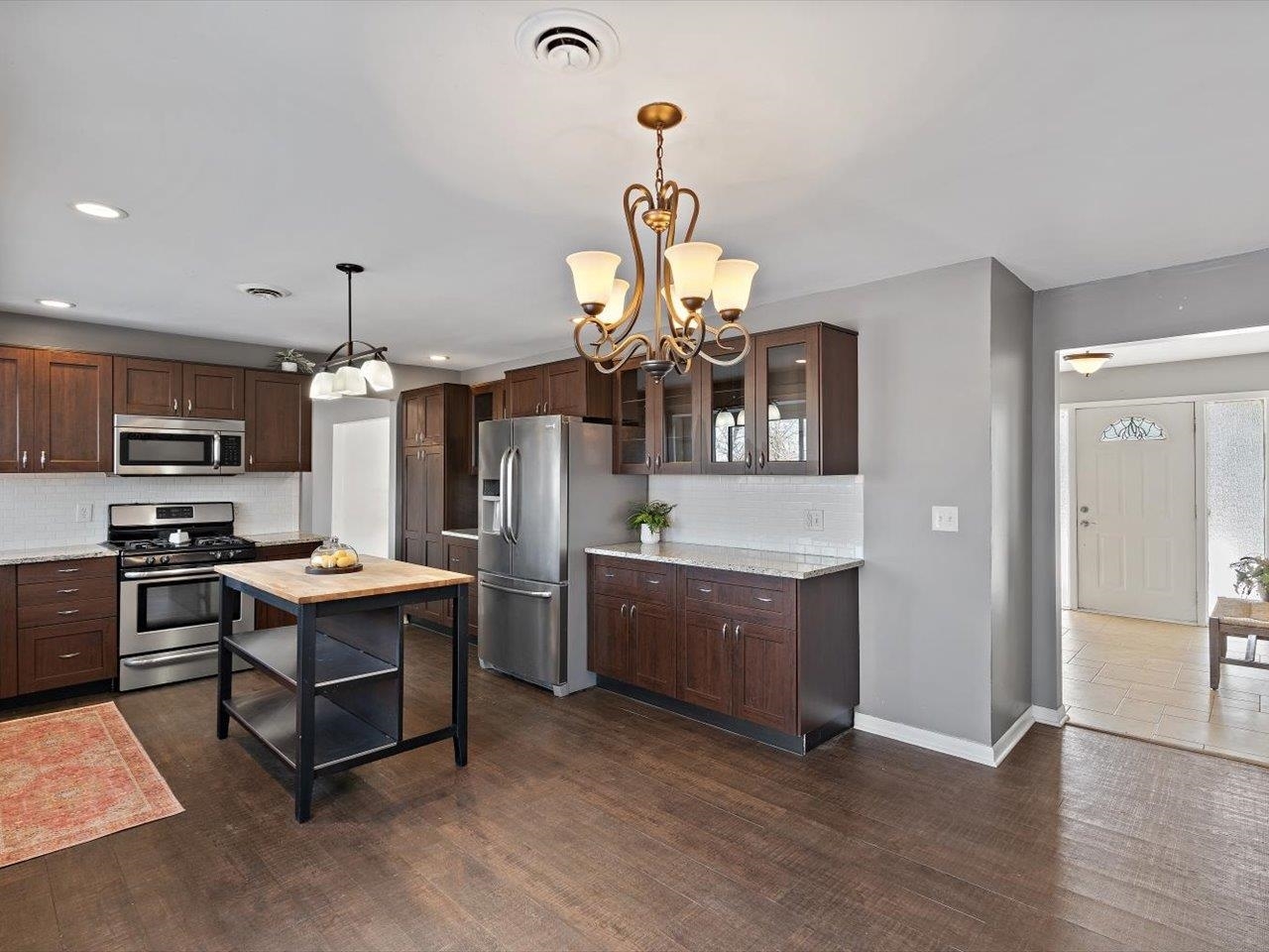 8210 Ridgewood Road Rock Island, IL 61201 - Photo 25 of 60 a kitchen with stainless steel appliances granite countertop a stove and a refrigerator