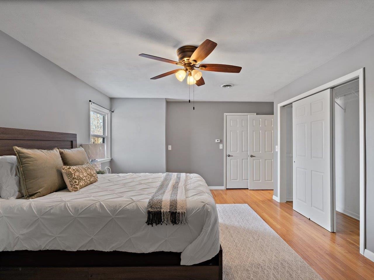 8210 Ridgewood Road Rock Island, IL 61201 - Photo 35 of 60 a bedroom with a bed and a ceiling fan