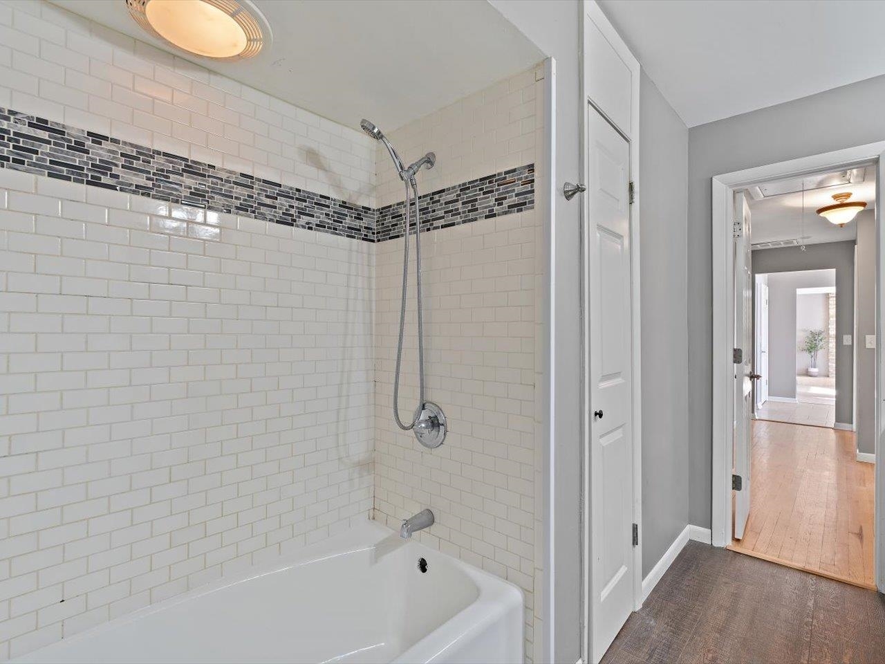 8210 Ridgewood Road Rock Island, IL 61201 - Photo 43 of 60 a bathroom with a shower a tub and a shower