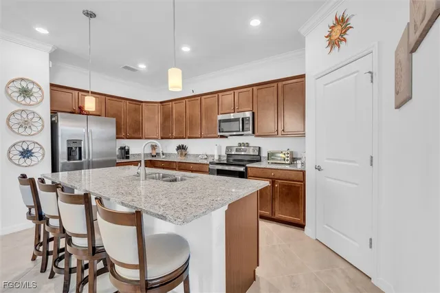 a kitchen with granite countertop a table chairs microwave and sink
