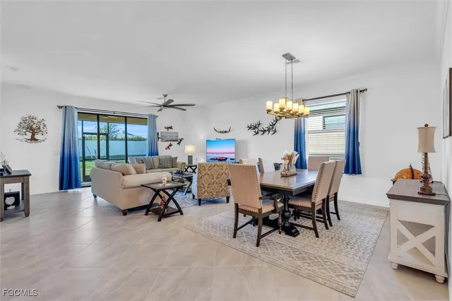 a living room with furniture ceiling fan and a window