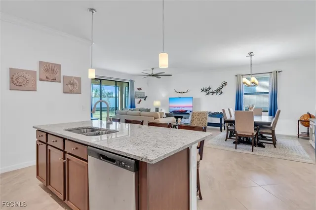 a kitchen with stainless steel appliances granite countertop a stove a sink a microwave a refrigerator and cabinets