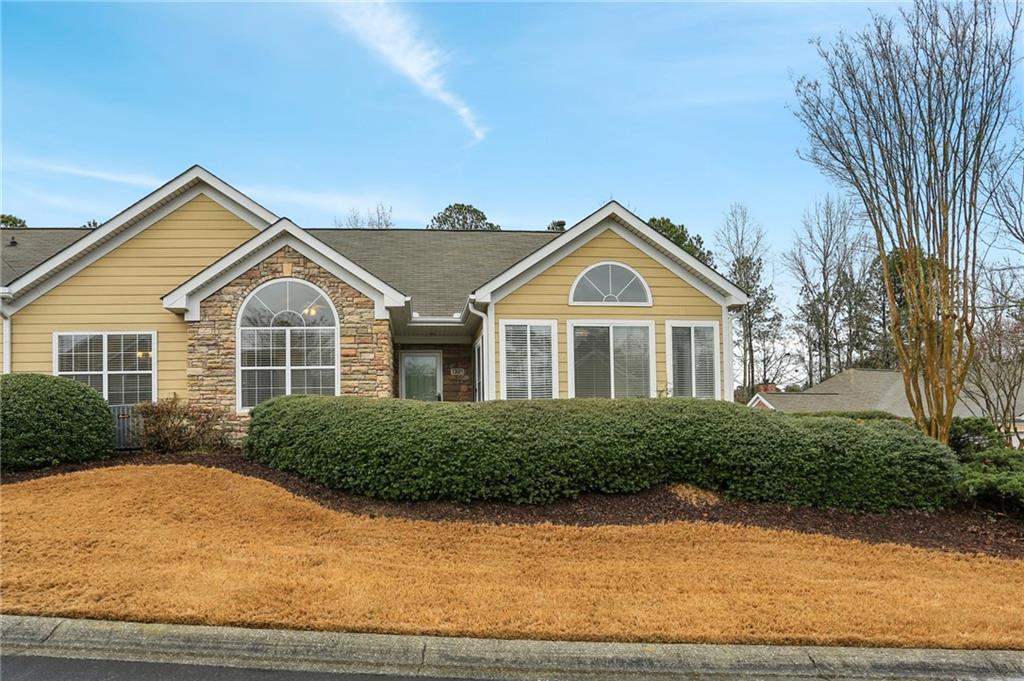 2191 Rockbridge Road Southwest, Unit 1301 Stone Mountain, GA 30087 - Photo 1 of 22 a front view of a house with a yard