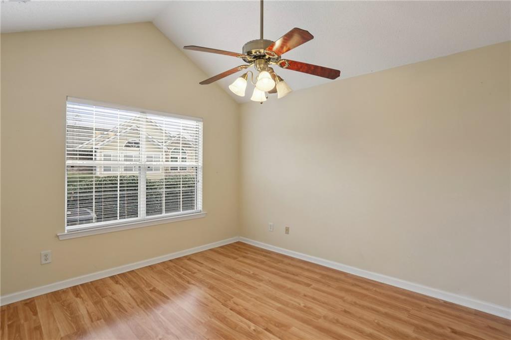 2191 Rockbridge Road Southwest, Unit 1301 Stone Mountain, GA 30087 - Photo 19 of 22 a view of an empty room with wooden floor and a window