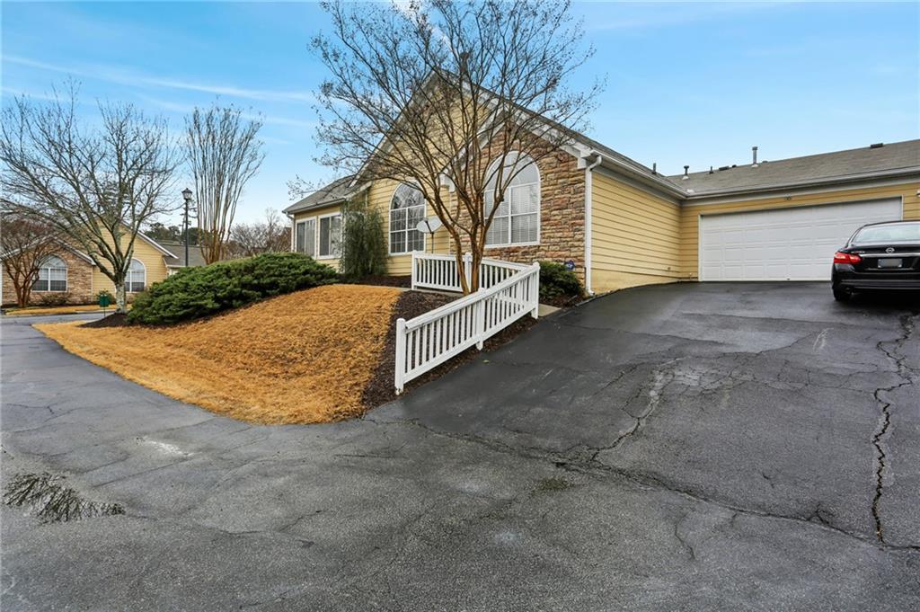 2191 Rockbridge Road Southwest, Unit 1301 Stone Mountain, GA 30087 - Photo 22 of 22 a view of a house with a yard and garage