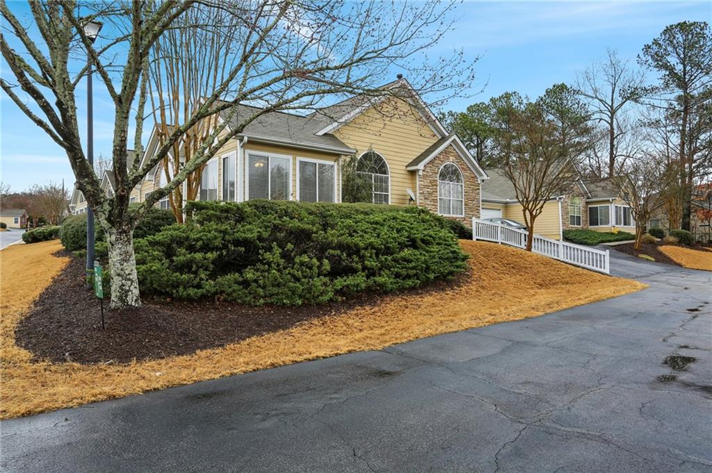 2191 Rockbridge Road Southwest, Unit 1301 Stone Mountain, GA 30087 - Photo 3 of 22 a front view of a house with a yard and garage