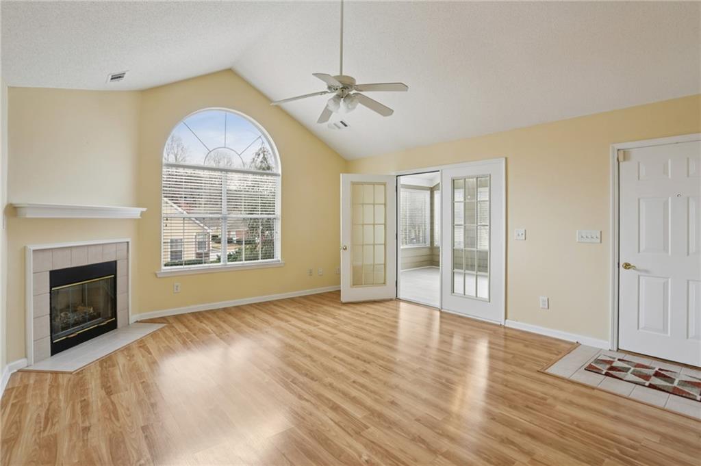 2191 Rockbridge Road Southwest, Unit 1301 Stone Mountain, GA 30087 - Photo 6 of 22 a view of an empty room with a fireplace and a window