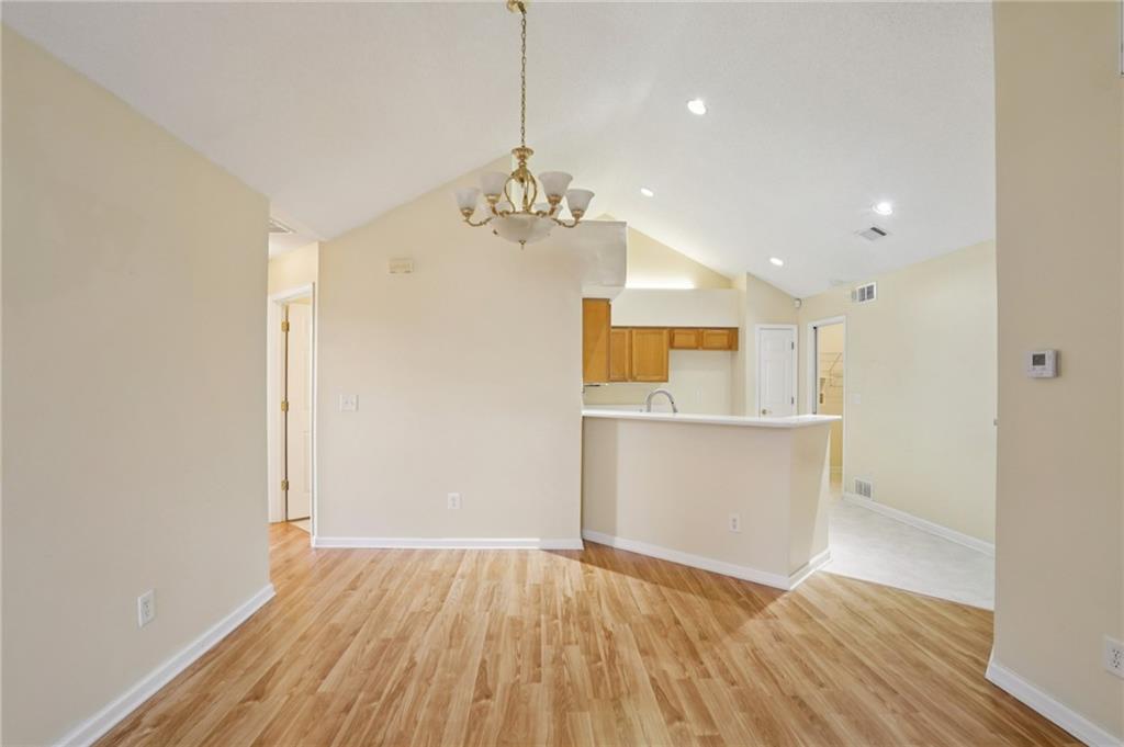 2191 Rockbridge Road Southwest, Unit 1301 Stone Mountain, GA 30087 - Photo 9 of 22 a view of a kitchen with wooden floor and a sink