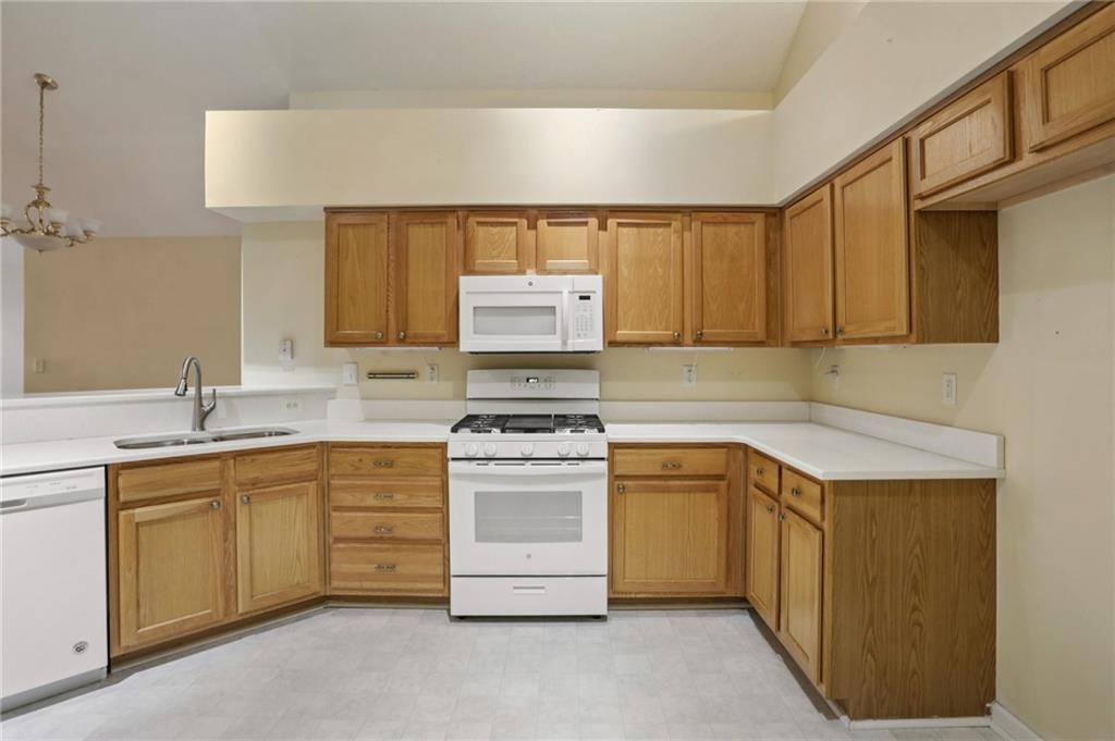 2191 Rockbridge Road Southwest, Unit 1301 Stone Mountain, GA 30087 - Photo 10 of 22 a kitchen with a stove sink and cabinets