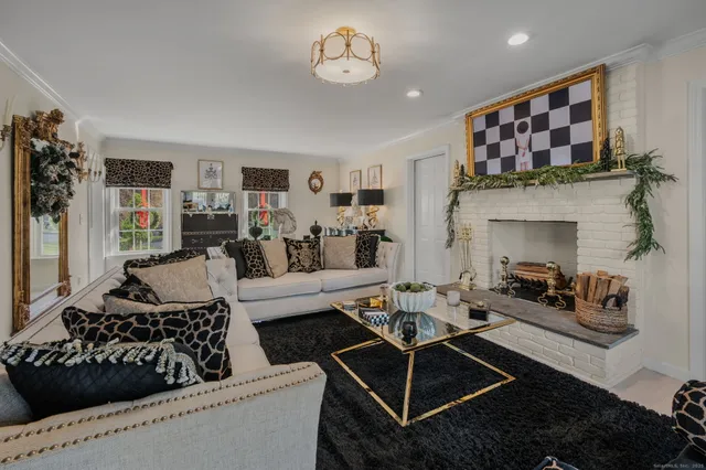 a living room with furniture a window and a chandelier