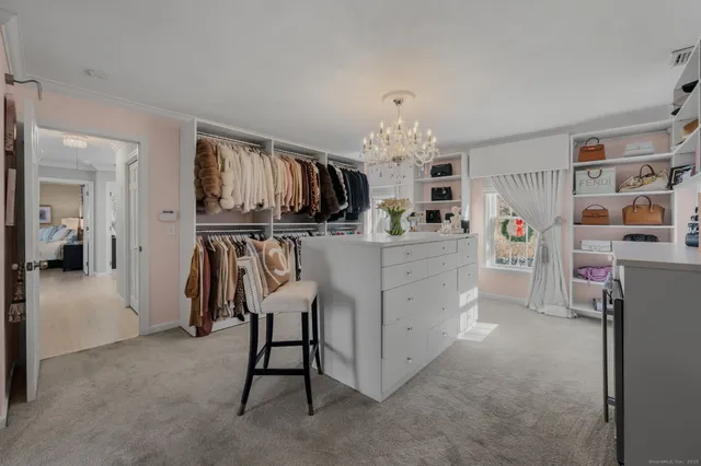 a kitchen with stainless steel appliances a table chairs and a refrigerator