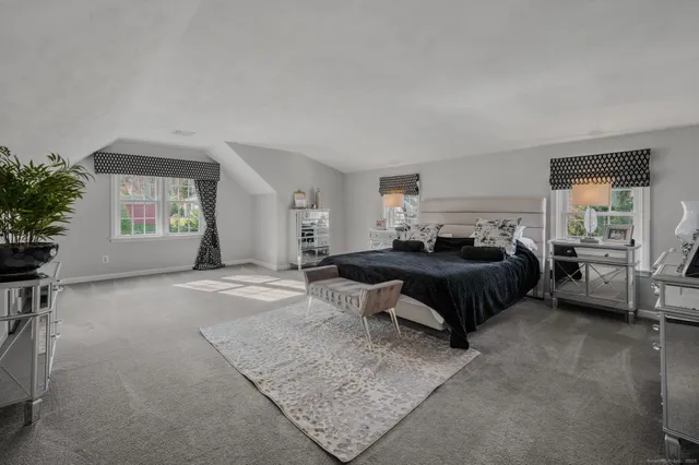 a bedroom with a bed and a television