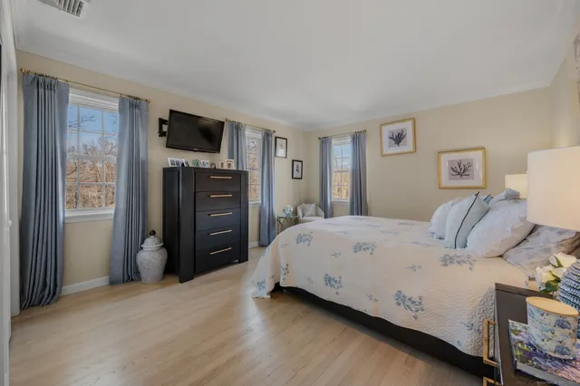 a bedroom with furniture and a window