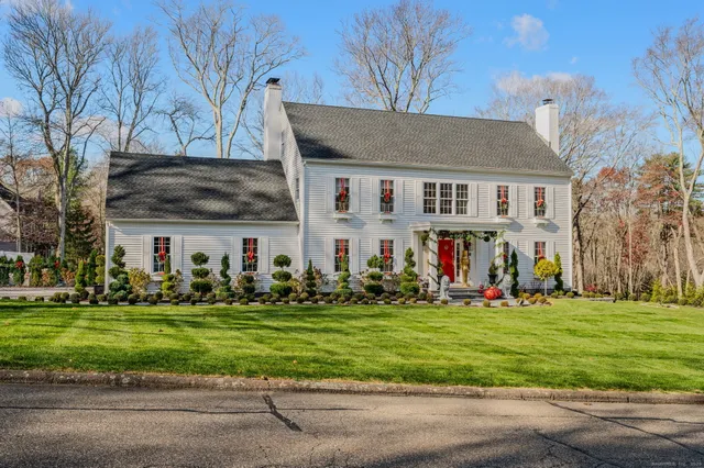 a kitchen with a sink table and chairs