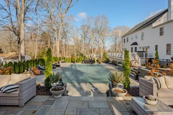 a view of a patio with couches and table and chairs and potted plants