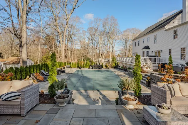 a view of a patio with couches and table and chairs and potted plants