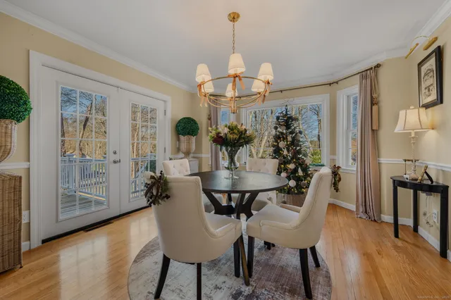 a view of a dining room with furniture wooden floor and a chandelier