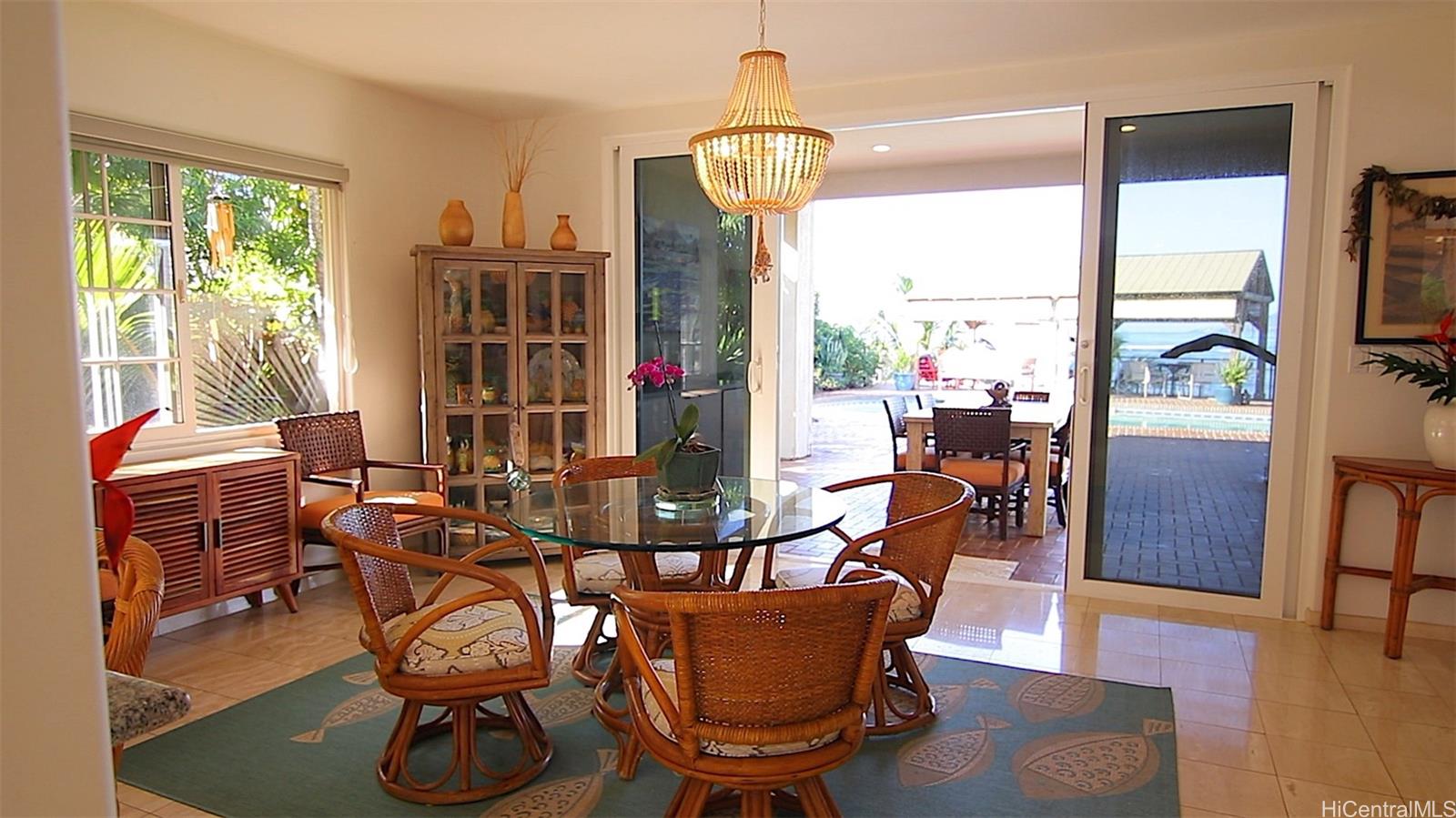 469 Portlock Road Honolulu, HI 96825 - Photo 12 of 25 a dining room with furniture a chandelier and wooden floor