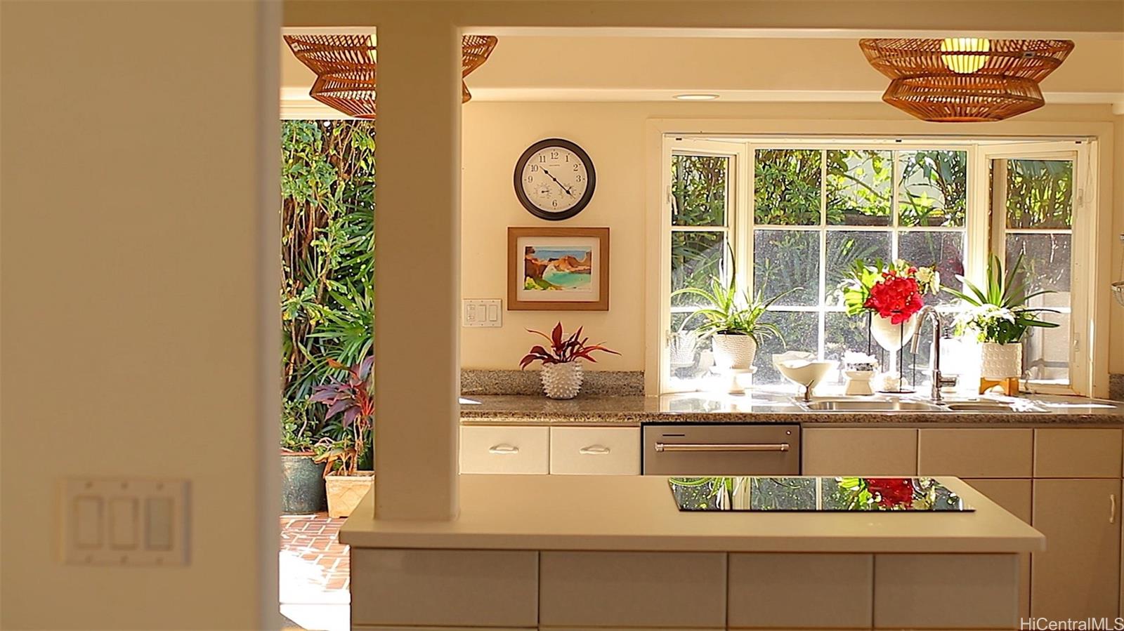 469 Portlock Road Honolulu, HI 96825 - Photo 14 of 25 a table with a vase and flowers on it