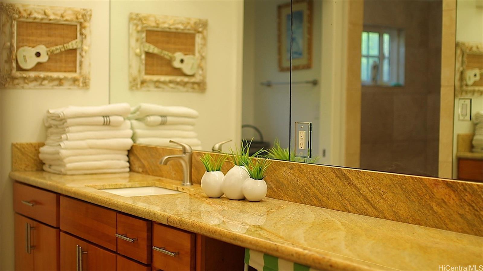469 Portlock Road, Unit A Honolulu, HI 96825 - Photo 15 of 25 a bathroom with a granite countertop sink and a mirror