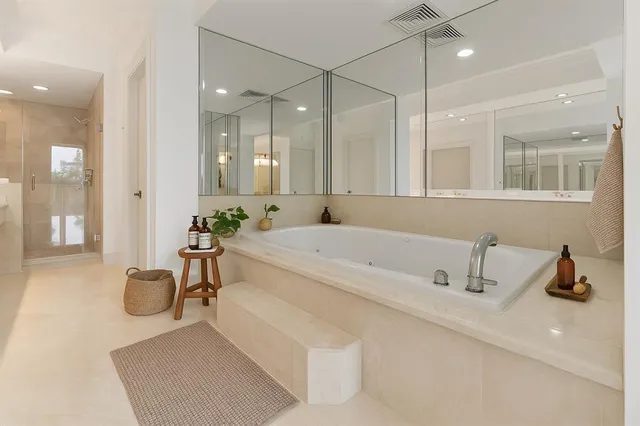 a bathroom with a granite countertop sink double vanity and a mirror