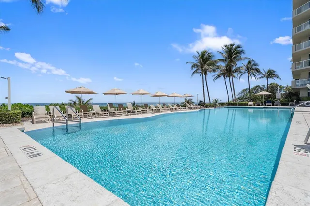 a view of a swimming pool with a chair and table
