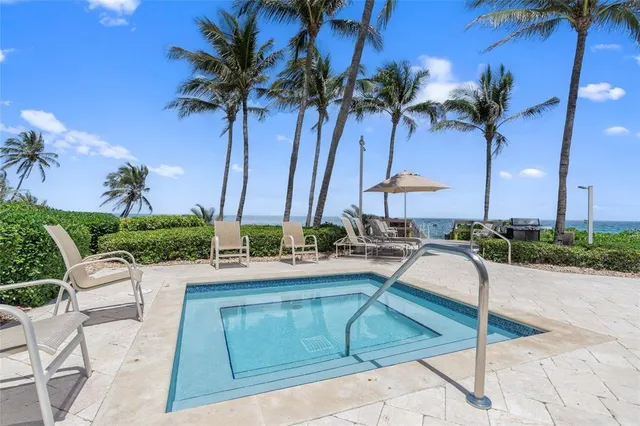 a view of an ocean with a palm tree