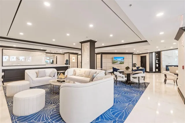 a living room with furniture a large window and dining table