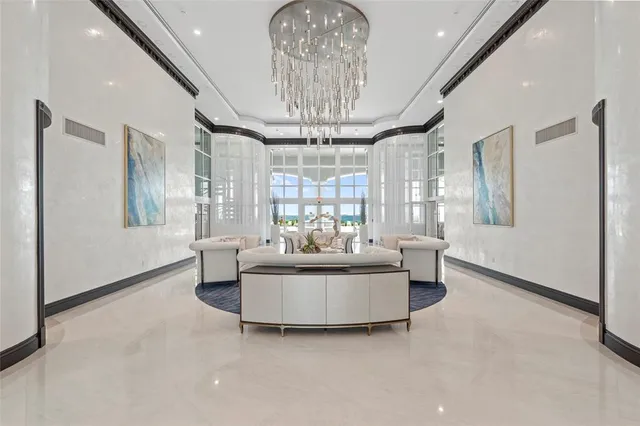 a living room with fireplace furniture and a chandelier
