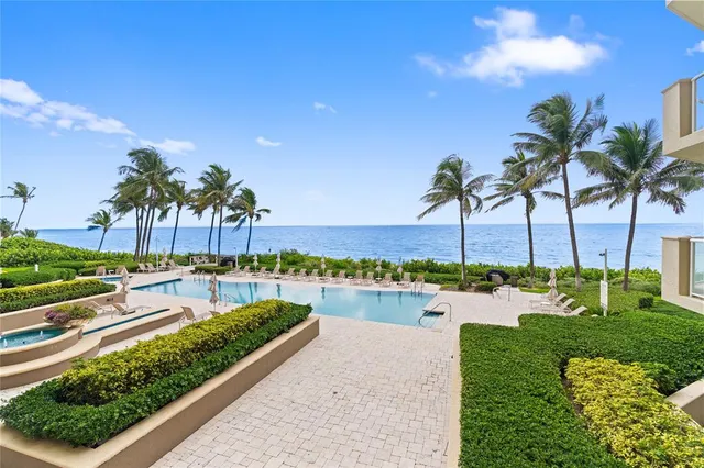 a view of a swimming pool and lounge chairs