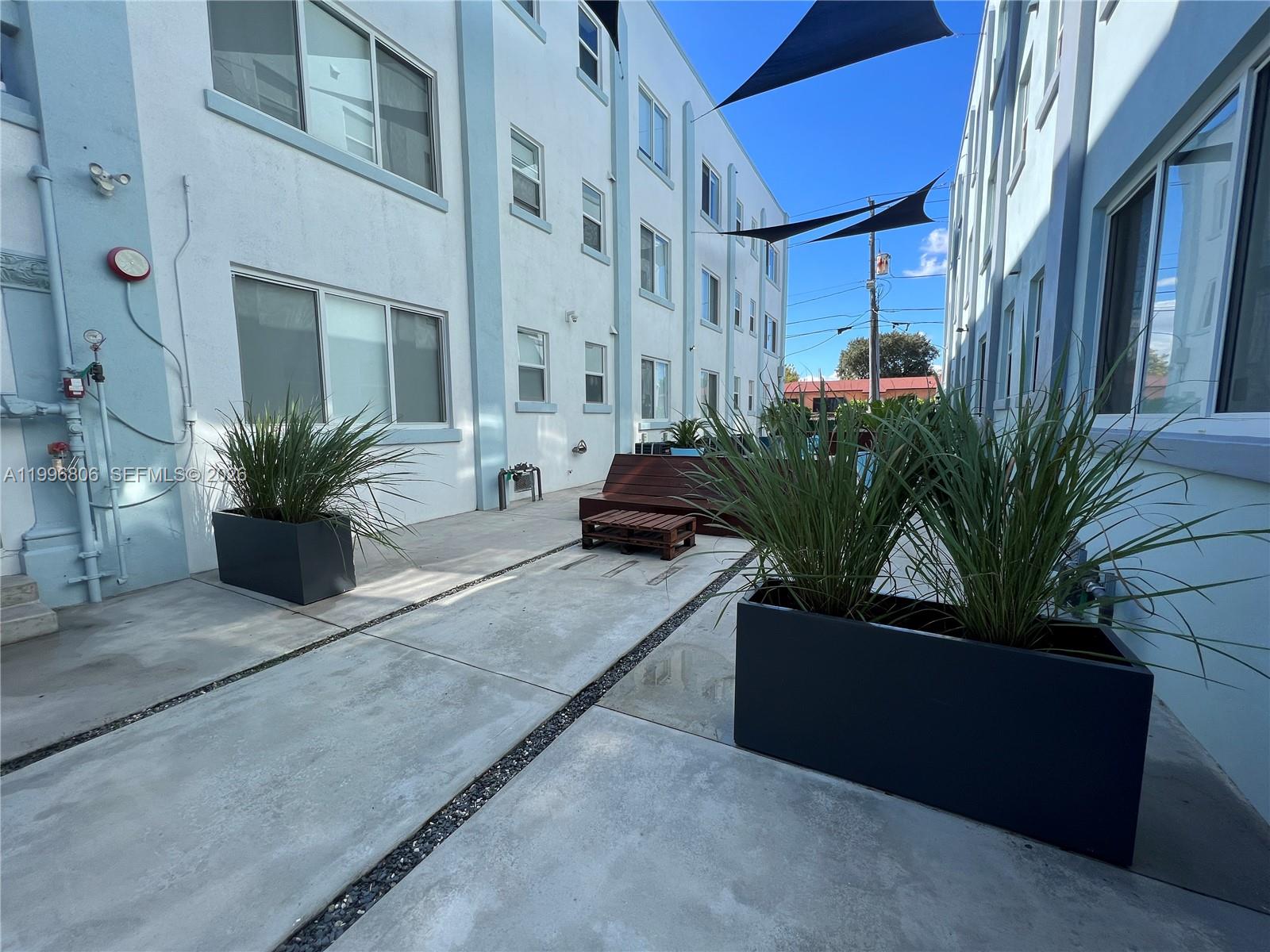 1818 Southwest 22nd Avenue, Unit 1 Miami, FL 33145 - Photo 18 of 18 a potted plant sitting in front of a building