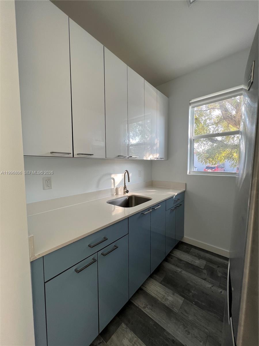 1818 Southwest 22nd Avenue, Unit 1 Miami, FL 33145 - Photo 4 of 18 a kitchen with sink cabinets and window