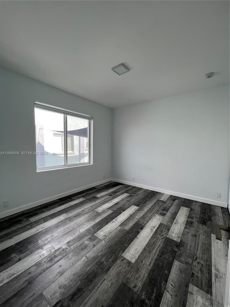 1818 Southwest 22nd Avenue, Unit 1 Miami, FL 33145 - Photo 8 of 18 a view of a room with wooden floor and windows