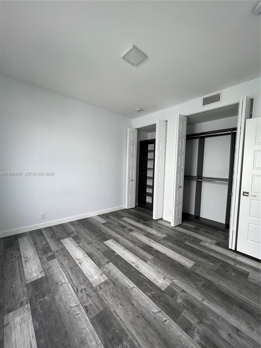 1818 Southwest 22nd Avenue, Unit 1 Miami, FL 33145 - Photo 9 of 18 a view of a livingroom with wooden floor and a window