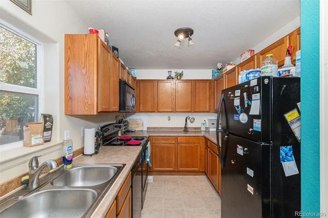 a kitchen with a sink appliances and cabinets