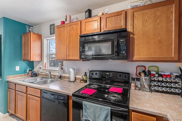 a kitchen with stainless steel appliances granite countertop a sink and cabinets