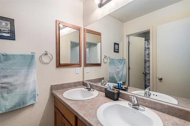 a bathroom with 2 sink and a mirror